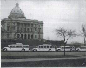 Four buses parked in front of the Minnesota State Capitol building